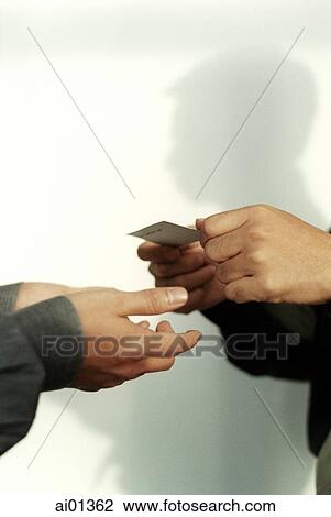 Two executives exchanging business card, close-up. View Large Photo Image Stock Image - Two executives exchanging business card, close-up.. Fotosearch
