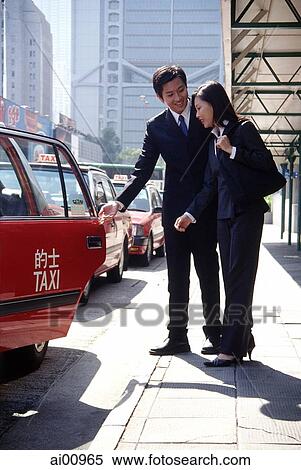Two executives getting into taxi View Large Photo Image Stock Photography - Two executives getting into taxi. Fotosearch