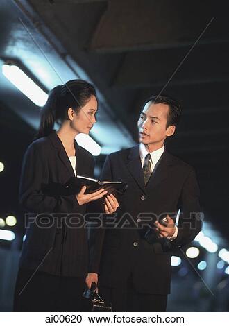 Two executives talking at night View Large Photo Image Stock Image - Two executives talking at night. Fotosearch