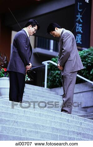 Two male executives bowing on stairway View Large Photo Image Stock Photo - Two male executives bowing on stairway. Fotosearch