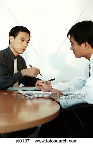 Stock Image - Two male executives meeting.. Fotosearch
