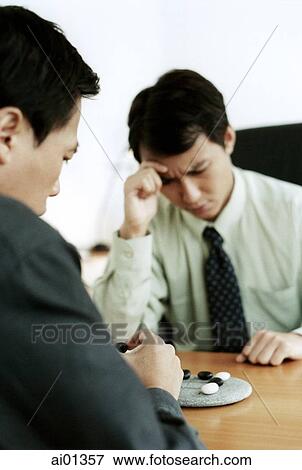 Two male executives playing tic tac toe View Large Photo Image Stock Photo - Two male executives playing tic tac toe. Fotosearch