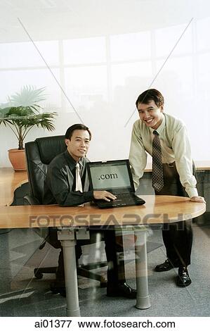 Two male executives with laptop computer. View Large Photo Image Stock Photo - Two male executives with laptop computer.. Fotosearch