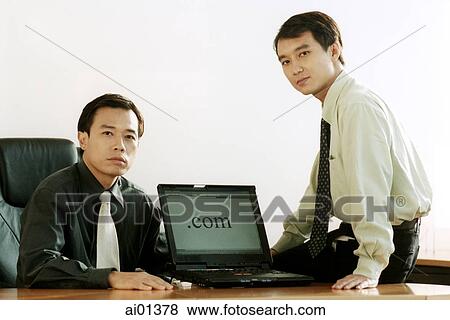 Two male executives with laptop computer. View Large Photo Image Stock Photo - Two male executives with laptop computer.. Fotosearch