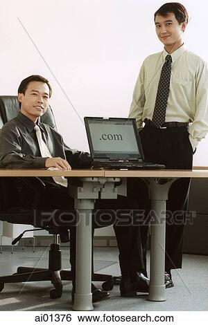 Two male executives with laptop computer. View Large Photo Image Stock Photograph - Two male executives with laptop computer.. Fotosearch