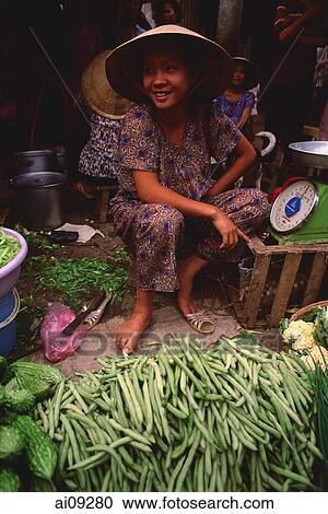 Vietnam, Cai Be, Mekong Delta, Woman selling vegetables at market stall. View Large Photo Image Stock Image - Vietnam, Cai Be, Mekong Delta, Woman selling vegetables at market stall.. Fotosearch