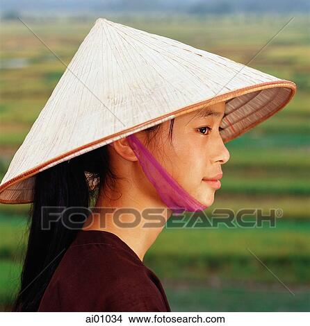 Vietnam, Chua Huong Province, young Vietnamese girl wearing conical hat View Large Photo Image Picture - Vietnam, Chua Huong Province, young Vietnamese girl wearing conical hat. Fotosearch