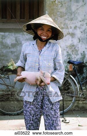 Vietnam, girl with pig at market View Large Photo Image Stock Image - Vietnam, girl with pig at market. Fotosearch