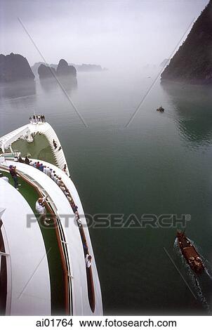 Vietnam, Halong Bay, cruise ship and small fishing boat. View Large Photo Image Picture - Vietnam, Halong Bay, cruise ship and small fishing boat.. Fotosearch