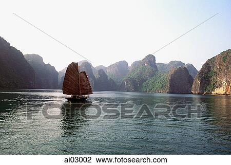 Vietnam, Halong Bay, Fishing junk sailing amongst the islands View Large Photo Image Stock Image - Vietnam, Halong Bay, Fishing junk sailing amongst the islands. Fotosearch