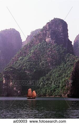 Vietnam, Halong Bay, Fishing junk sailing amongst the islands View Large Photo Image Stock Image - Vietnam, Halong Bay, Fishing junk sailing amongst the islands. Fotosearch