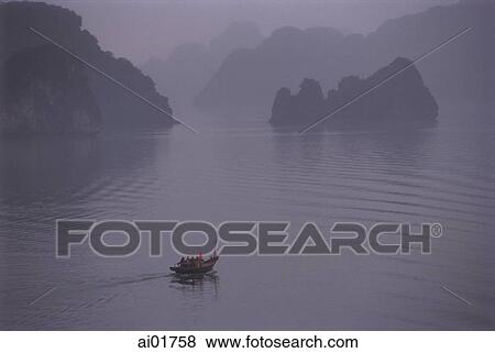 Stock Photo - Vietnam, Halong Bay, lone fishing boat in the mist.. Fotosearch