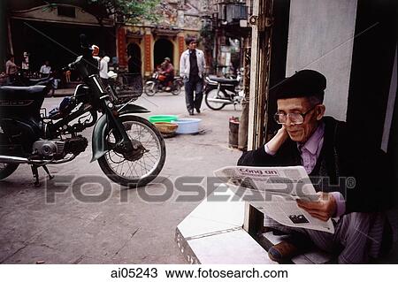 Vietnam, Hanoi, An elderly man sitting in a doorway reading a Vietnamese newspaper. View Large Photo Image Stock Image - Vietnam, Hanoi, An elderly man sitting in a doorway reading a Vietnamese newspaper.. Fotosearch