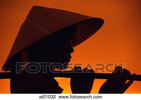 Vietnam, Hanoi, Young woman holding baskets at sunrise View Large Photo Image Stock Image - Vietnam, Hanoi, Young woman holding baskets at sunrise. Fotosearch