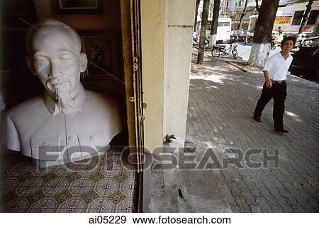 Vietnam, Ho Chi Minh City, A man walking past a large bust of Ho Chi Minh. View Large Photo Image Stock Photo - Vietnam, Ho Chi Minh City, A man walking past a large bust of Ho Chi Minh.. Fotosearch