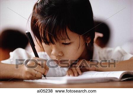 Vietnam, Ho Chi Minh City, A young girl concentrating on her studies. View Large Photo Image Stock Photo - Vietnam, Ho Chi Minh City, A young girl concentrating on her studies.. Fotosearch
