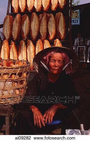 Stock Image - Vietnam, Ho Chi Minh city, Baguettes for sale at roadside stall.. Fotosearch