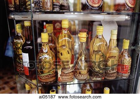 Stock Photo - Vietnam, Ho Chi Minh City, Ben Thanh Market, preserved snakes in jars are some of many local commodities available in the market.. Fotosearch