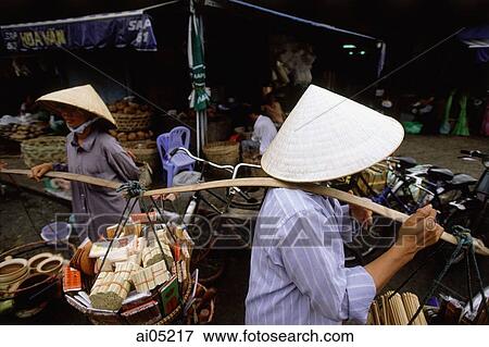 Vietnam, Ho Chi Minh City, District One, Women carrying goods to be sold. View Large Photo Image Stock Photo - Vietnam, Ho Chi Minh City, District One, Women carrying goods to be sold.. Fotosearch