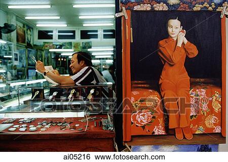 Vietnam, Ho Chi Minh City, District One, A worker in a jewelry and electronics shop reading a newspaper. View Large Photo Image Stock Photograph - Vietnam, Ho Chi Minh City, District One, A worker in a jewelry and electronics shop reading a newspaper.. Fotosearch