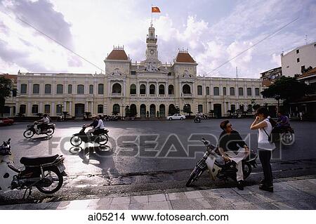 Vietnam, Ho Chi Minh City, Hotel De Ville (People's committee Building), people on motorcycles in foreground. View Large Photo Image Picture - Vietnam, Ho Chi Minh City, Hotel De Ville (People's committee Building), people on motorcycles in foreground.. Fotosearch