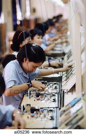 Vietnam, Ho Chi Minh City, Women working to assemble circuit boards in a factory. View Large Photo Image Stock Photograph - Vietnam, Ho Chi Minh City, Women working to assemble circuit boards in a factory.. Fotosearch