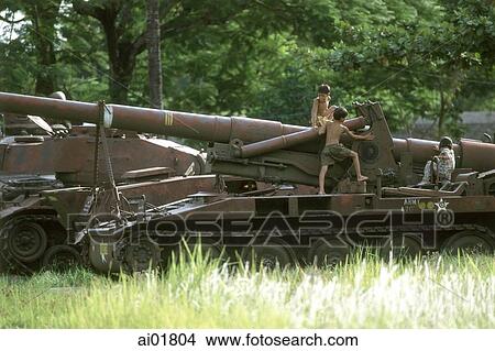 Picture - Vietnam, Hue, children playing with cannons at military museum.. Fotosearch