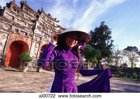 Vietnam, Hue, the Citadel, woman in traditional Vietnamese dress View Large Photo Image Stock Image - Vietnam, Hue, the Citadel, woman in traditional Vietnamese dress. Fotosearch