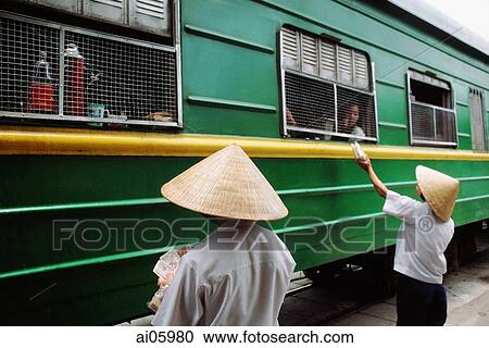 Vietnam, Locals outside the Reunification express that runs from Ho Chi Minh City (Saigon) to Hanoi View Large Photo Image Stock Image - Vietnam, Locals outside the Reunification express that runs from Ho Chi Minh City (Saigon) to Hanoi. Fotosearch