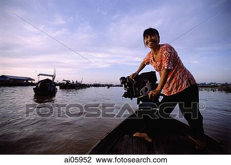 Vietnam, Long Xuyen, Woman driving boat in floating markets on Mekong River. View Large Photo Image Stock Image - Vietnam, Long Xuyen, Woman driving boat in floating markets on Mekong River.. Fotosearch