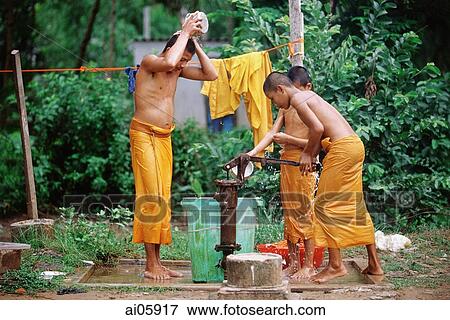 Stock Photo - Vietnam, Mekong Delta region, Bac Lieu, Buddhist monks bathing at water pump.. Fotosearch