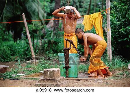 Stock Photo - Vietnam, Mekong Delta region, Bac Lieu, Buddhist monks bathing at water pump.. Fotosearch
