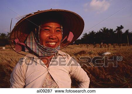 Vietnam, Outside Vinh Long, Mekong delta, Smiling rice farmer at rice harvest / threshing time. View Large Photo Image Stock Photo - Vietnam, Outside Vinh Long, Mekong delta, Smiling rice farmer at rice harvest / threshing time.. Fotosearch