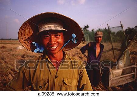 Vietnam, Outside Vinh Long, Mekong delta, Smiling rice farmers at rice harvest / threshing time. View Large Photo Image Stock Photography - Vietnam, Outside Vinh Long, Mekong delta, Smiling rice farmers at rice harvest / threshing time.. Fotosearch