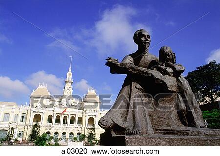 Stock Image - Vietnam, Saigon, Statue of Ho Chi-Minh with Hotel De Ville in background. Fotosearch