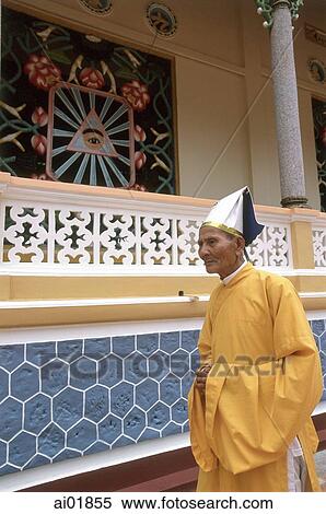 Vietnam, Tay Ninh, Cao Dai lay priest in front of "One Eye of God" symbol. View Large Photo Image Stock Photography - Vietnam, Tay Ninh, Cao Dai lay priest in front of "One Eye of God" symbol.. Fotosearch