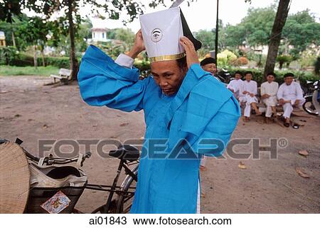Vietnam, Tay Ninh, Cao Dai priest arranging hat. View Large Photo Image Stock Image - Vietnam, Tay Ninh, Cao Dai priest arranging hat.. Fotosearch