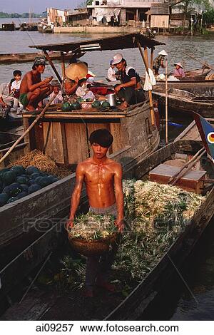 Vietnam, Vinh Long, Mekong Delta, Man unloading onions from boat. View Large Photo Image Stock Photo - Vietnam, Vinh Long, Mekong Delta, Man unloading onions from boat.. Fotosearch