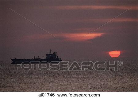 Stock Photograph - Vietnam, Vung Tau, oil tanker in the South China Sea at sunset.. Fotosearch