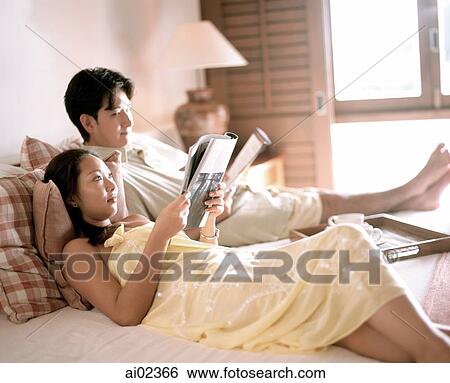 Woman and man in bed reading magazines. View Large Photo Image Stock Photograph - Woman and man in bed reading magazines.. Fotosearch