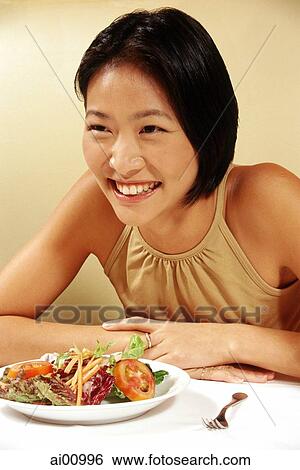 Woman at restaurant, smiling View Large Photo Image Stock Photograph - Woman at restaurant, smiling. Fotosearch