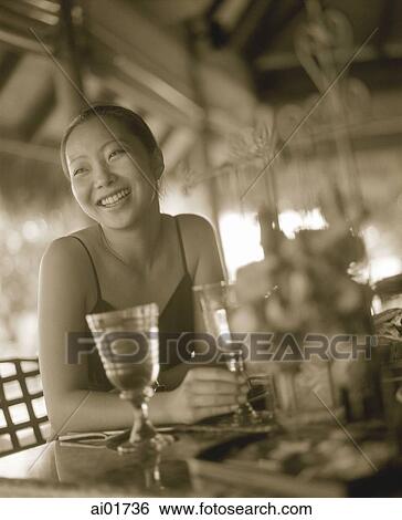 Woman at restaurant, smiling View Large Photo Image Stock Photograph - Woman at restaurant, smiling. Fotosearch