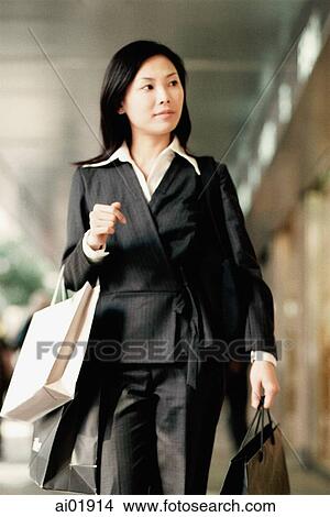Woman carrying shopping bags View Large Photo Image Picture - Woman carrying shopping bags. Fotosearch