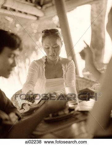 Woman eating with friends View Large Photo Image Stock Photo - Woman eating with friends. Fotosearch
