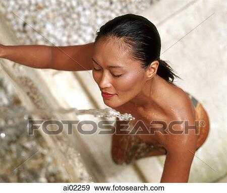 Woman getting wet by stream of water, topless View Large Photo Image Stock Photo - Woman getting wet by stream of water, topless. Fotosearch