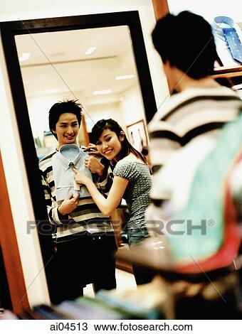 Woman helping man to choose clothes, reflection in mirror. View Large Photo Image Stock Image - Woman helping man to choose clothes, reflection in mirror.. Fotosearch