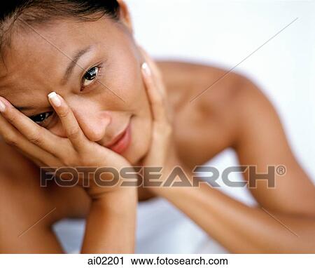 Woman holding head in hand, portrait, white background View Large Photo Image Stock Image - Woman holding head in hand, portrait, white background. Fotosearch