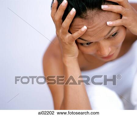 Woman holding head in hand, portrait, white background View Large Photo Image Stock Image - Woman holding head in hand, portrait, white background. Fotosearch