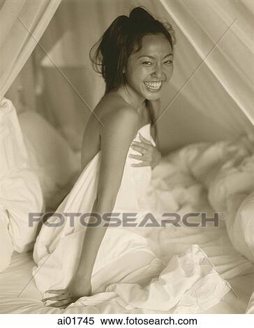 Woman in bed, smiling, portrait View Large Photo Image Stock Photography - Woman in bed, smiling, portrait. Fotosearch
