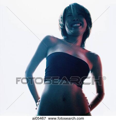 Woman in black tube top with hands behind her back against white background View Large Photo Image Stock Photo - Woman in black tube top with hands behind her back against white background. Fotosearch